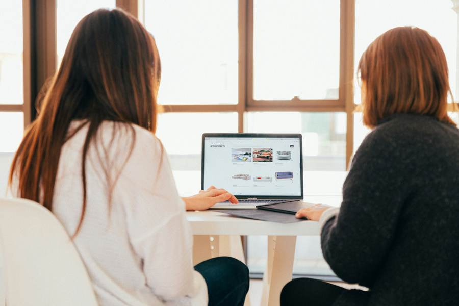Two people reading something together on a screen